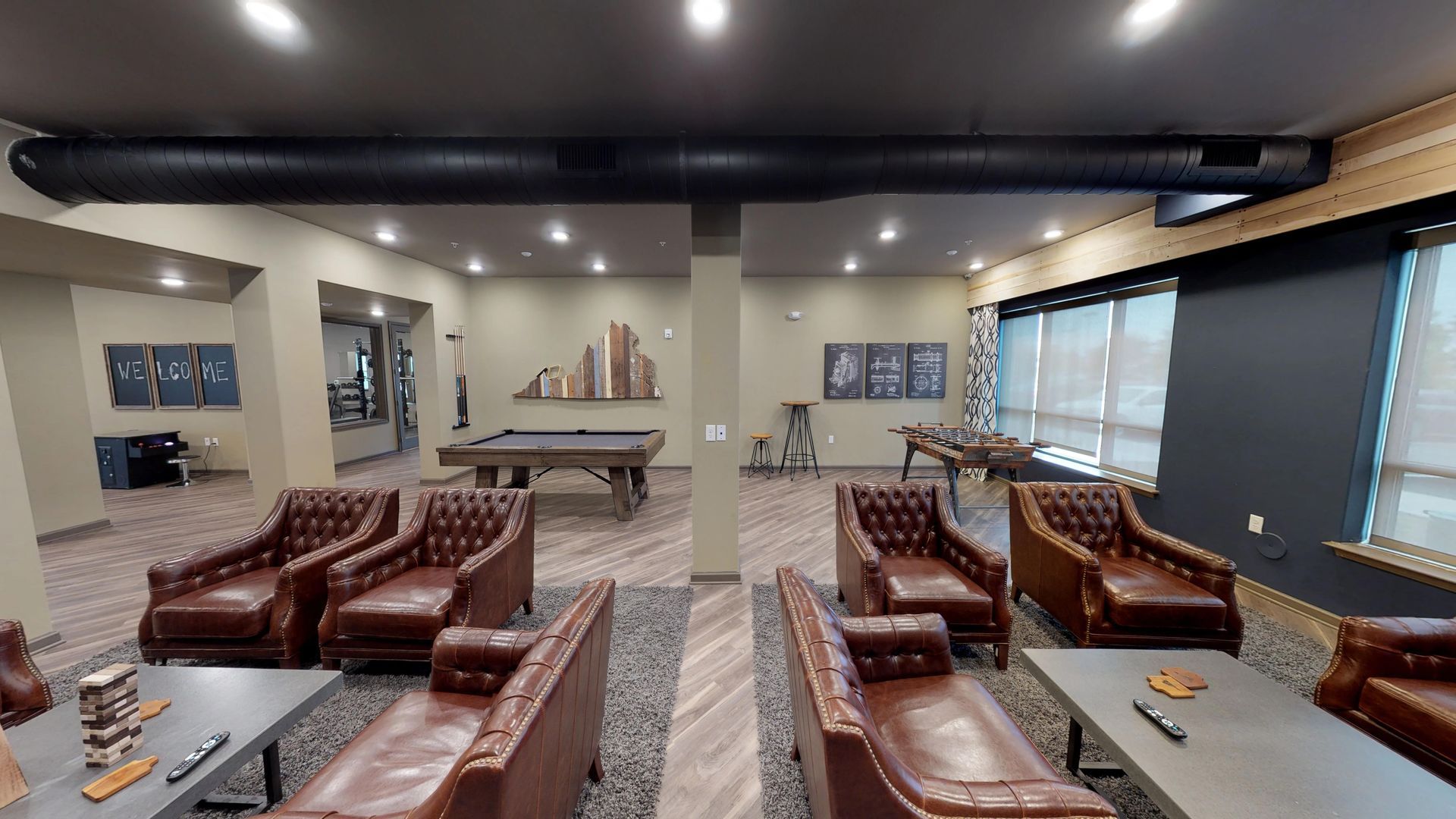 A living room filled with furniture and a pool table.