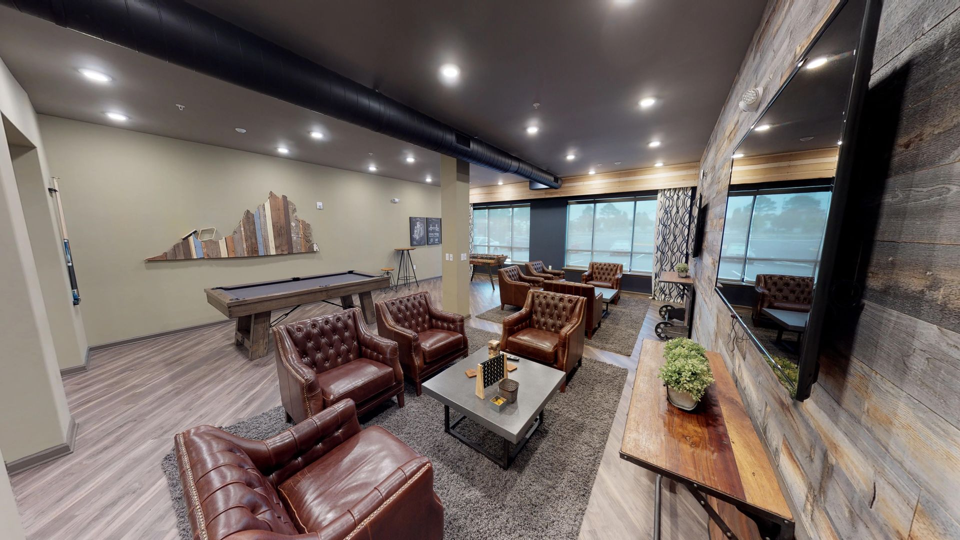 A living room filled with furniture and a pool table.