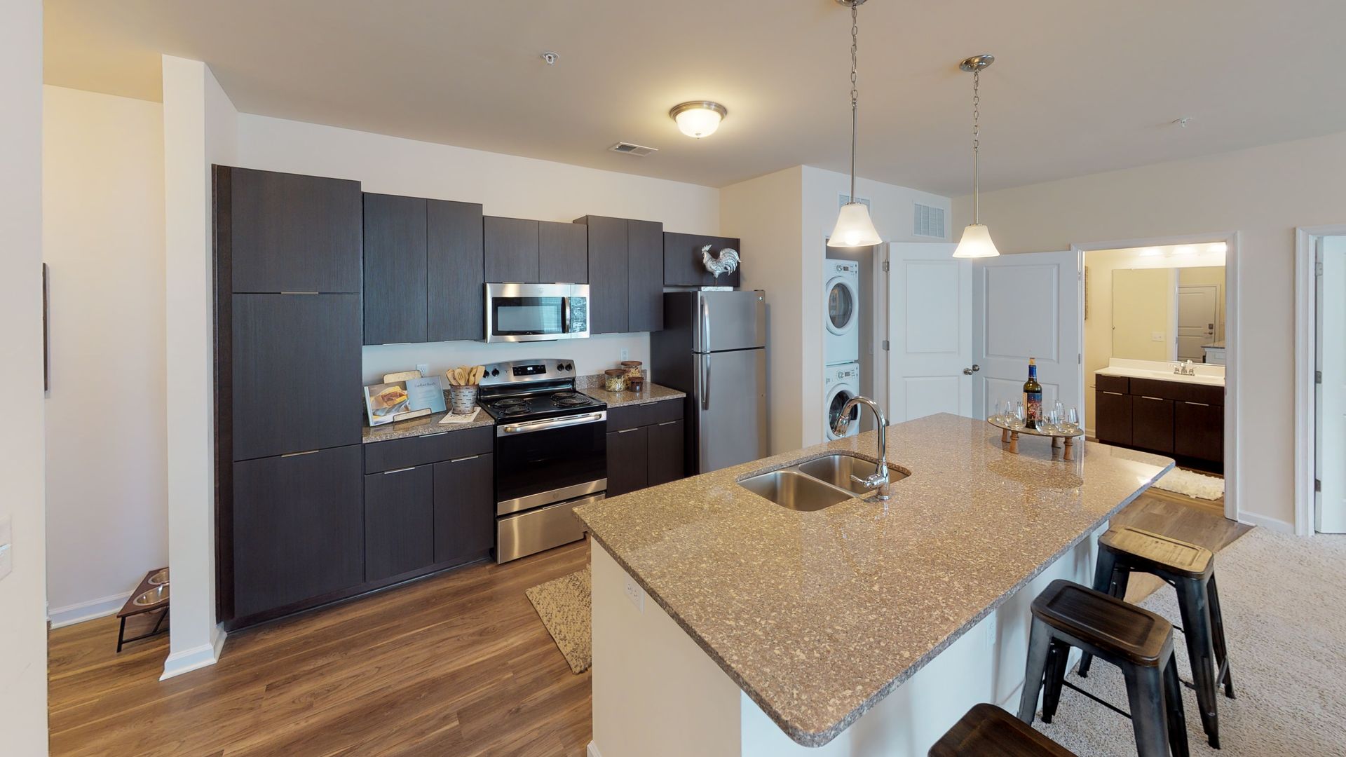 A kitchen with granite counter tops and stainless steel appliances.