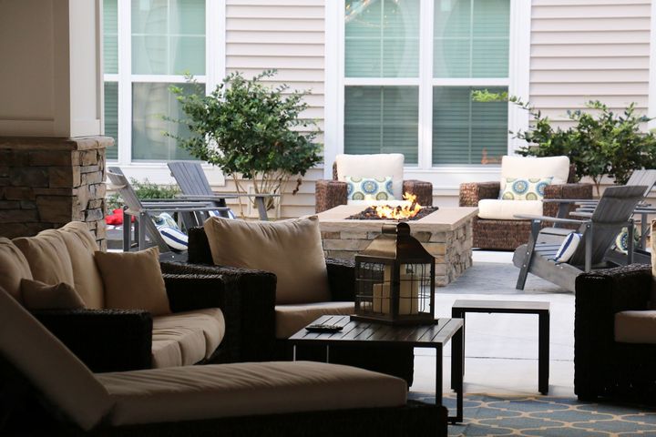There is a fire pit in the middle of the patio.