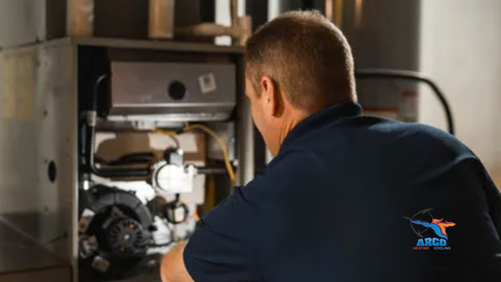 A man in a blue shirt is working on a heating system.