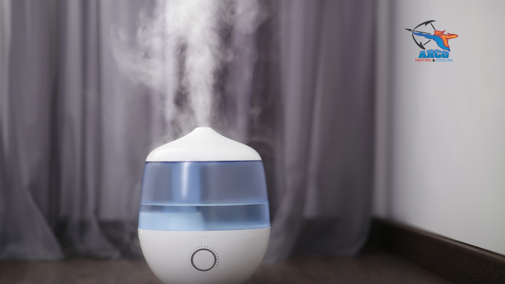 A white humidifier is sitting on a wooden floor in a room.
