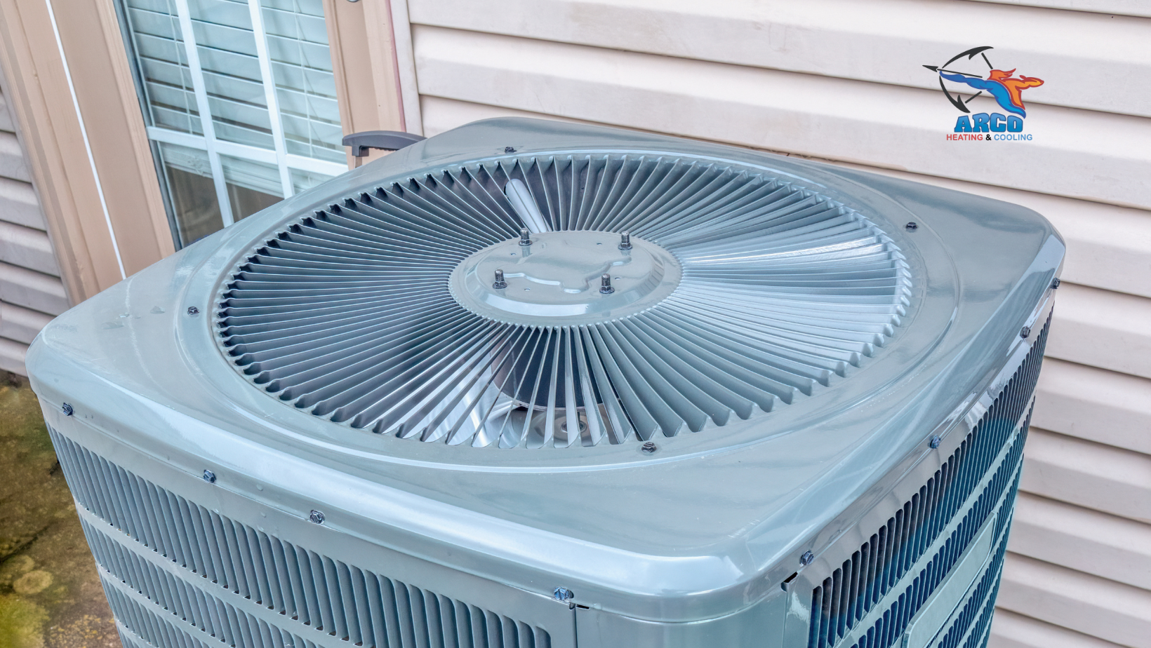 An air conditioner is sitting outside of a mobile home  next to a window.