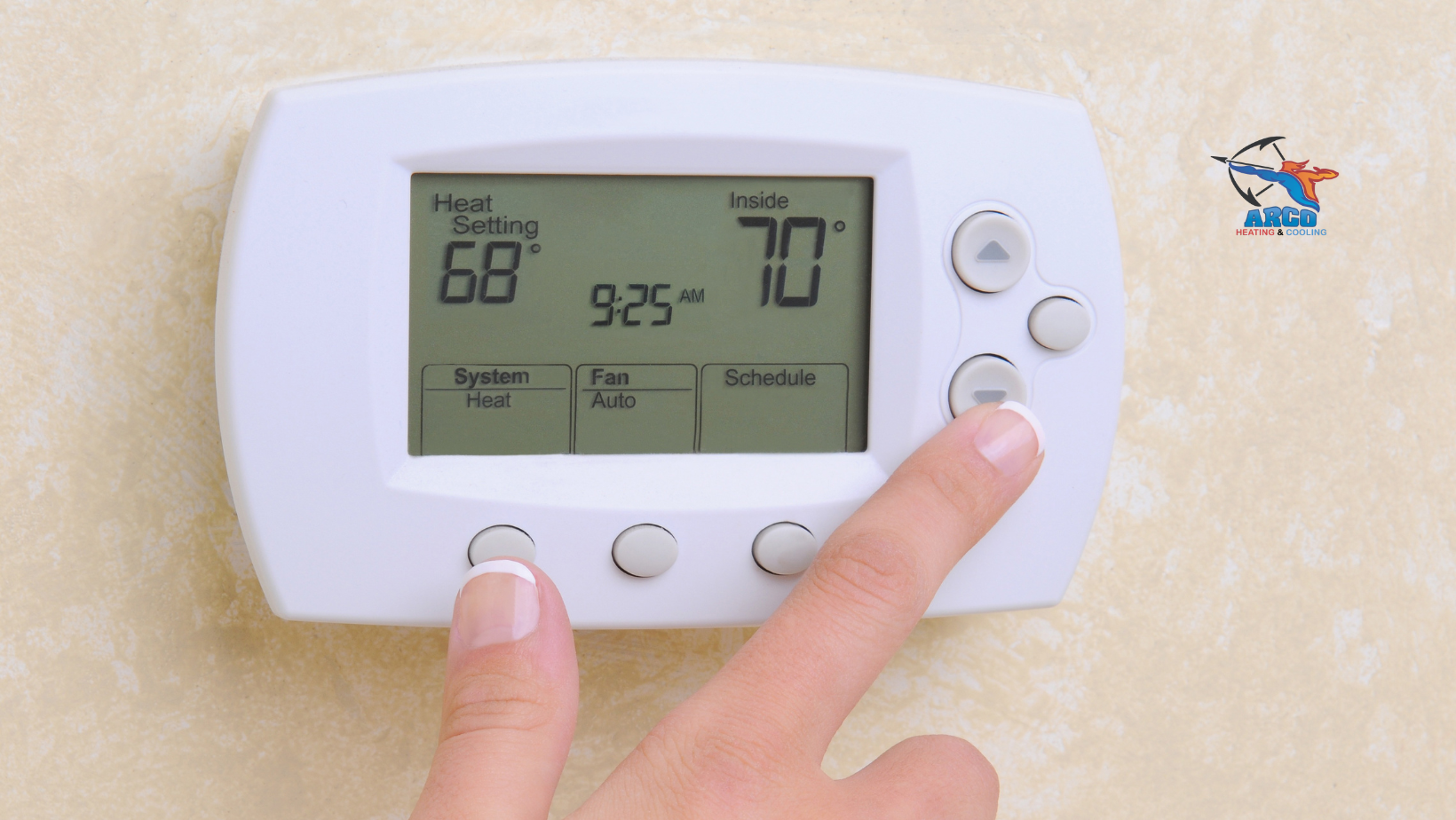 A person is pressing a button on a thermostat that is set to 70 degrees