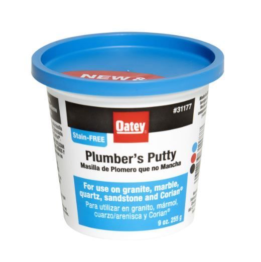 A container of plumber 's putty with a blue lid