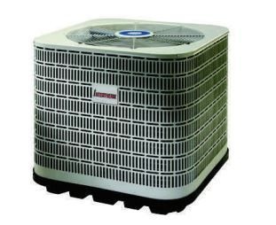 An air conditioner is sitting on top of a pallet on a white background.