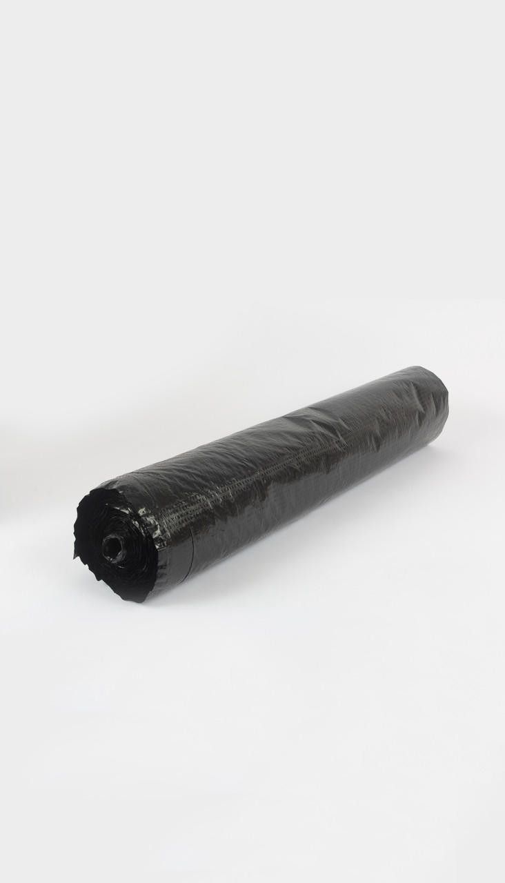 A roll of black plastic wrap is sitting on a white surface.