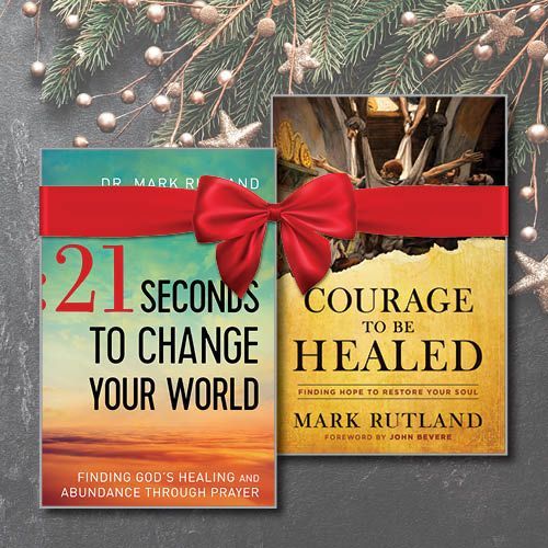 Two books tied with red ribbon: "21 Seconds to Change Your World" and "Courage to Be Healed". Holiday theme with ornaments.