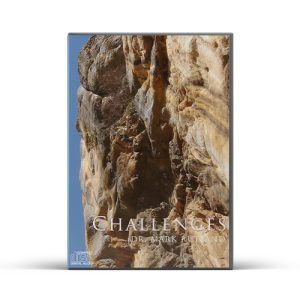 Box with a rocky cliff face on the front, blue sky visible on the left side, title "Challenges to Overcome".