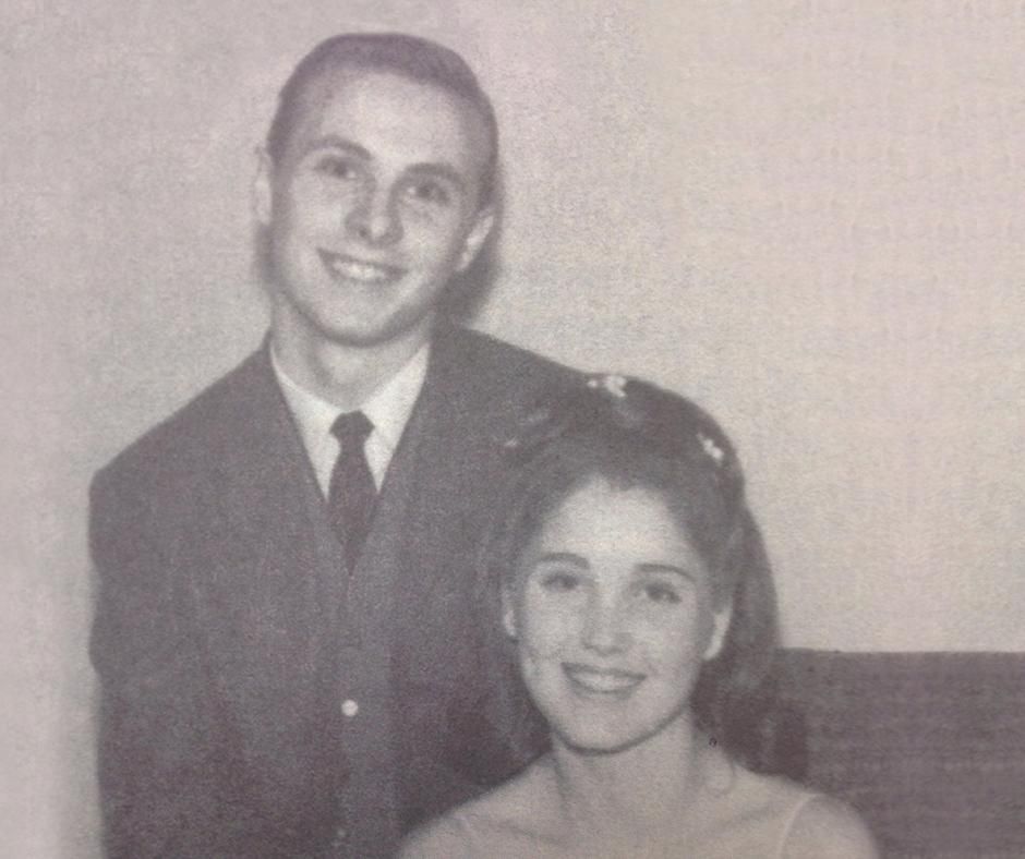 Dr. Mark and Allison Rutland smiling, posed for a photo. Man in suit, woman in formal attire.