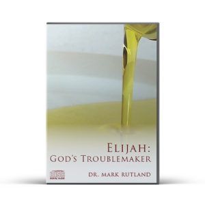 DVD cover: Gold liquid pouring into a bowl. Text reads "Elijah: God's Troublemaker" by Dr. Mark Rutland.