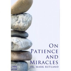 Stack of smooth stones next to a book titled "On Patience and Miracles" by Mark Rutland.