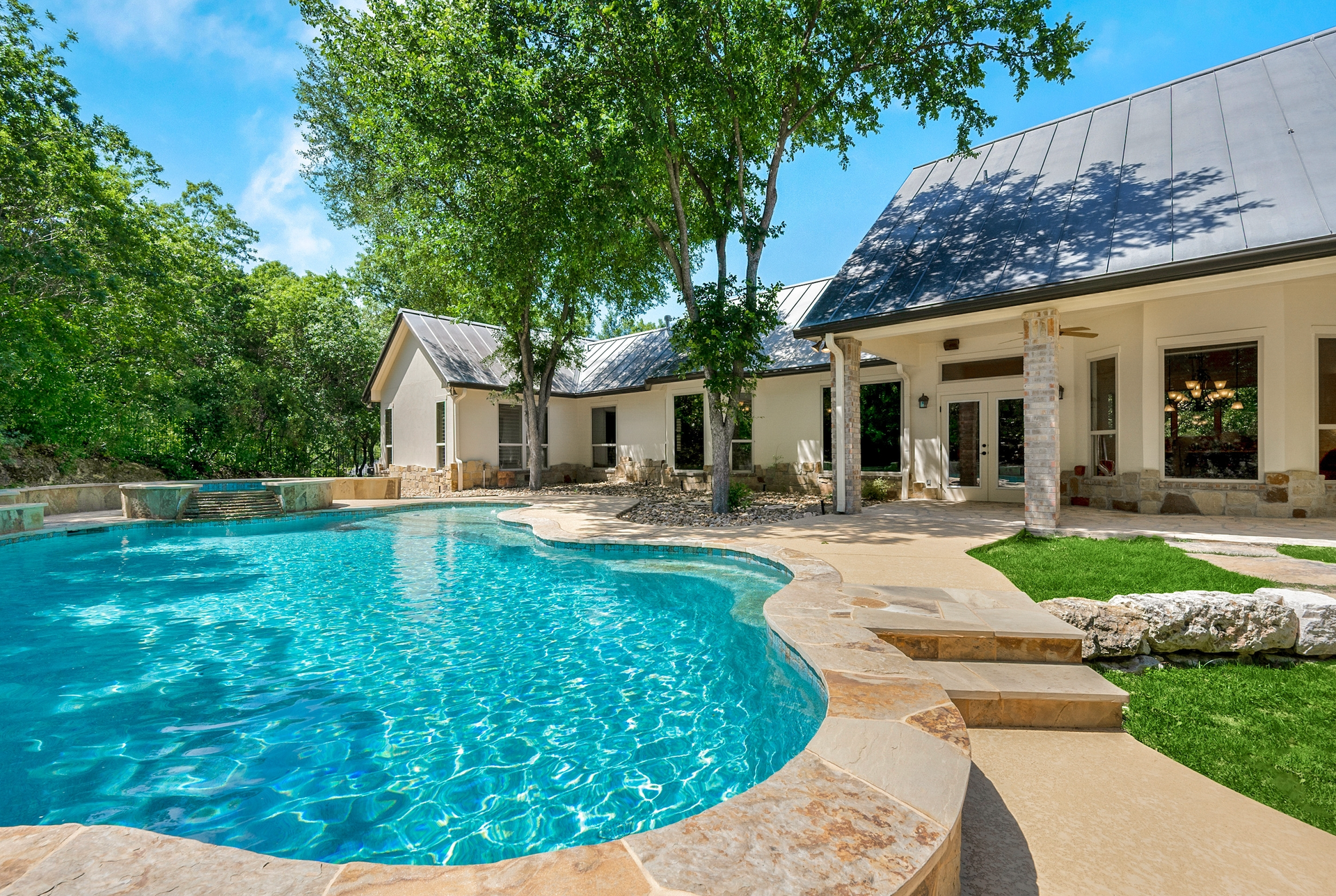 A large house with a large swimming pool in front of it
