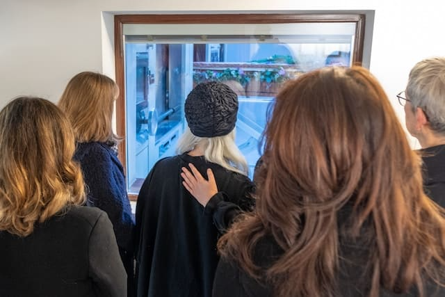 A group of people are looking out of a window.