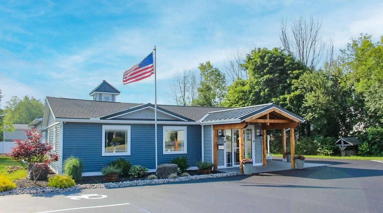 A blue house with an American flag flying in front of it.