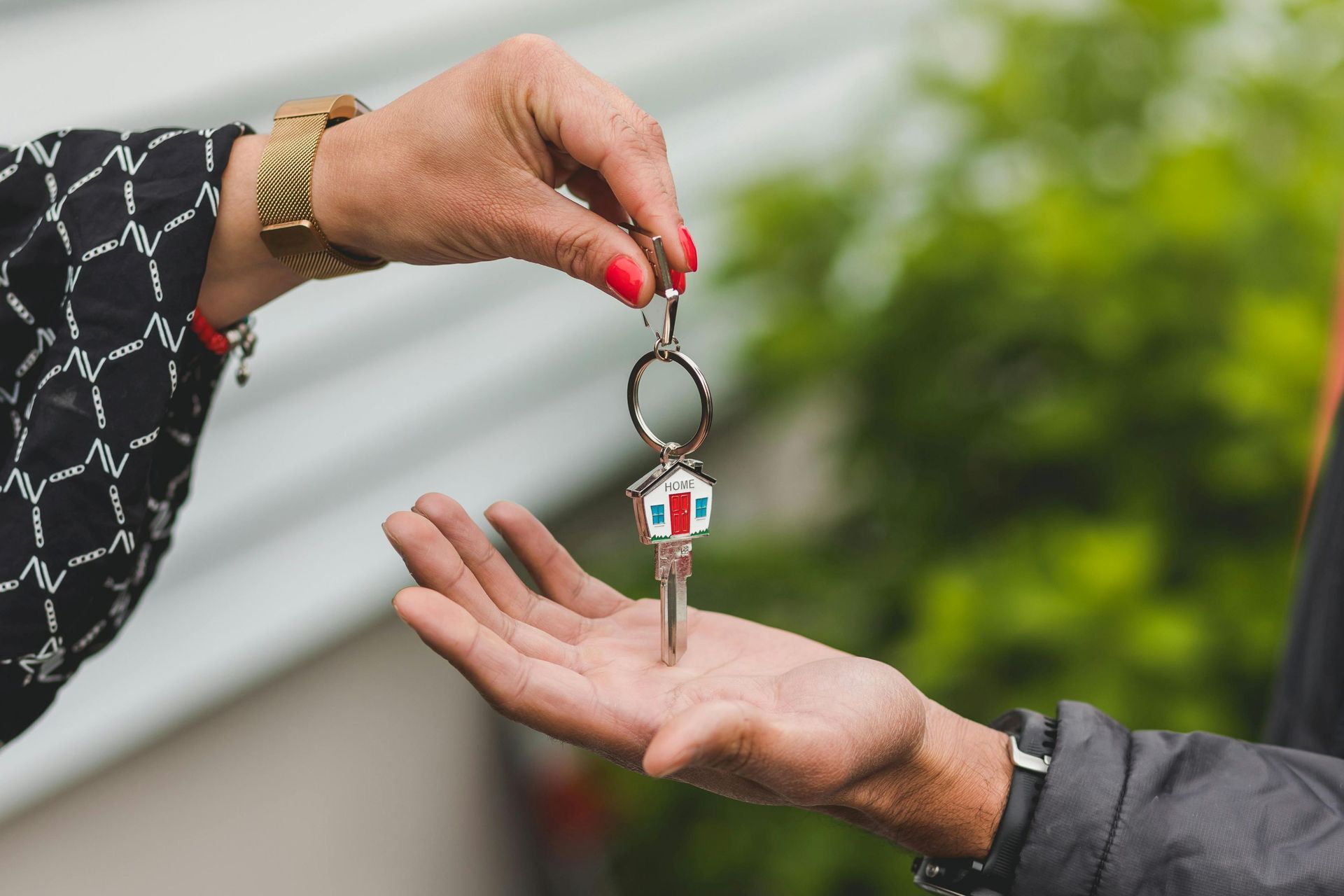 A person handing over a key to another person.