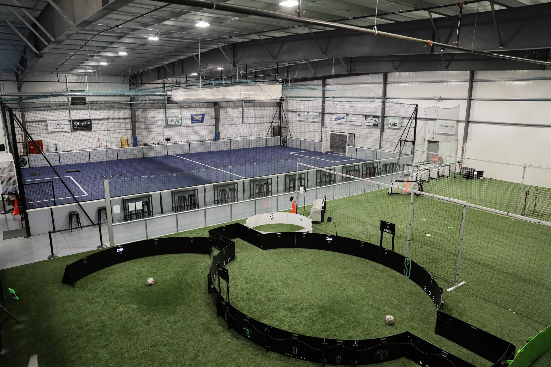 A large indoor soccer field with a circle in the middle of it.