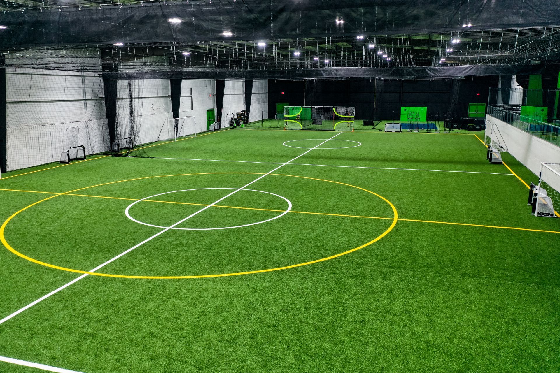 A city skyline with a river in the foreground and a cloudy sky in the background.