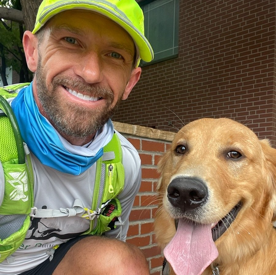 Denver Dog Runner is posing for a picture with his client's dog.