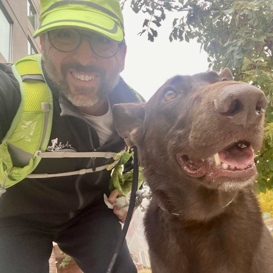 Jerry taking a selfie with a chocolate lab