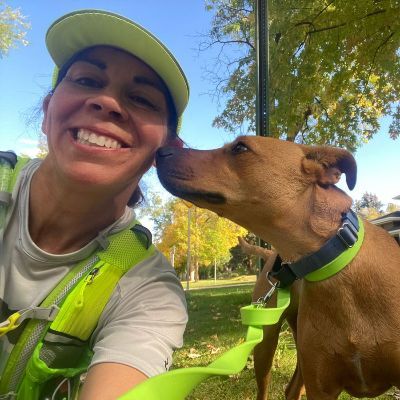Maggie taking a selfie with a dog.