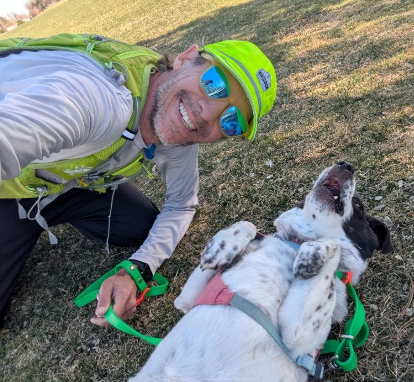 Brian taking a selfie with a dog on his back