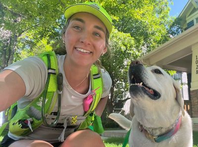 Kayla taking a selfie with a dog.