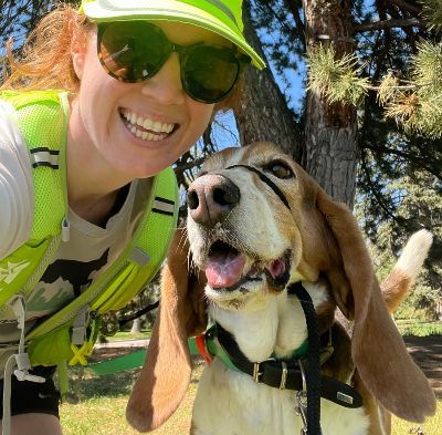Leah taking a selfie with a dog.