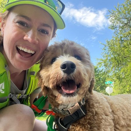 Leah taking a selfie with a dog.