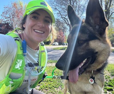 Lindsay taking a selfie with a German Shepherd.