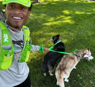 Noah taking a selfie with two dogs.
