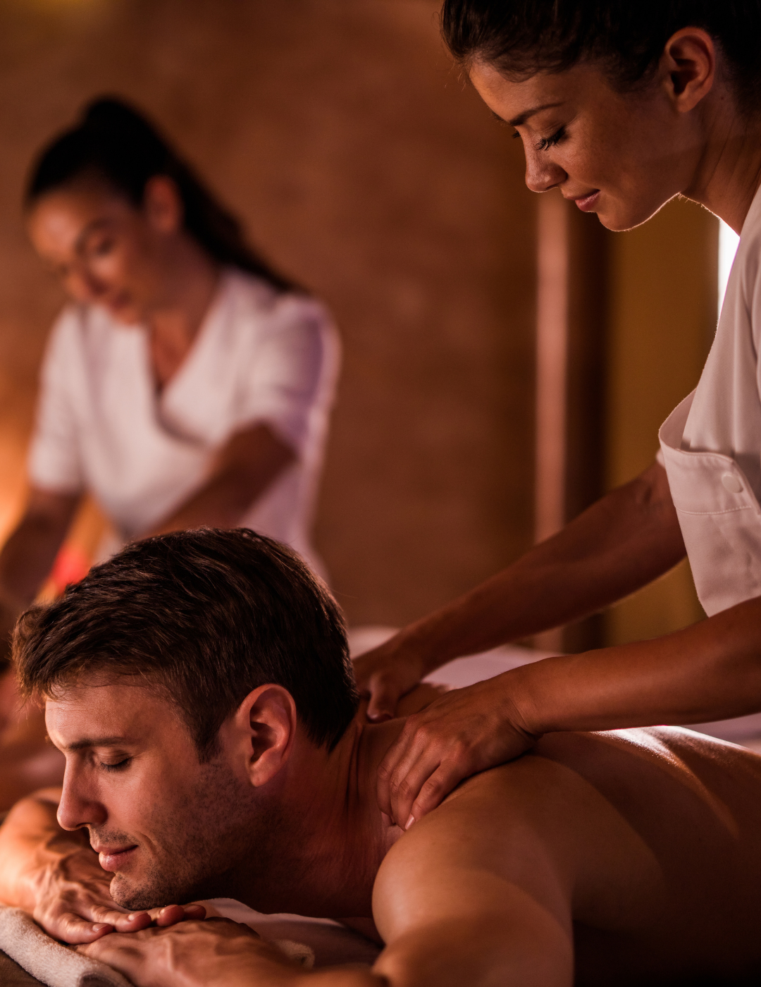 A man is getting a massage from a woman in a spa.