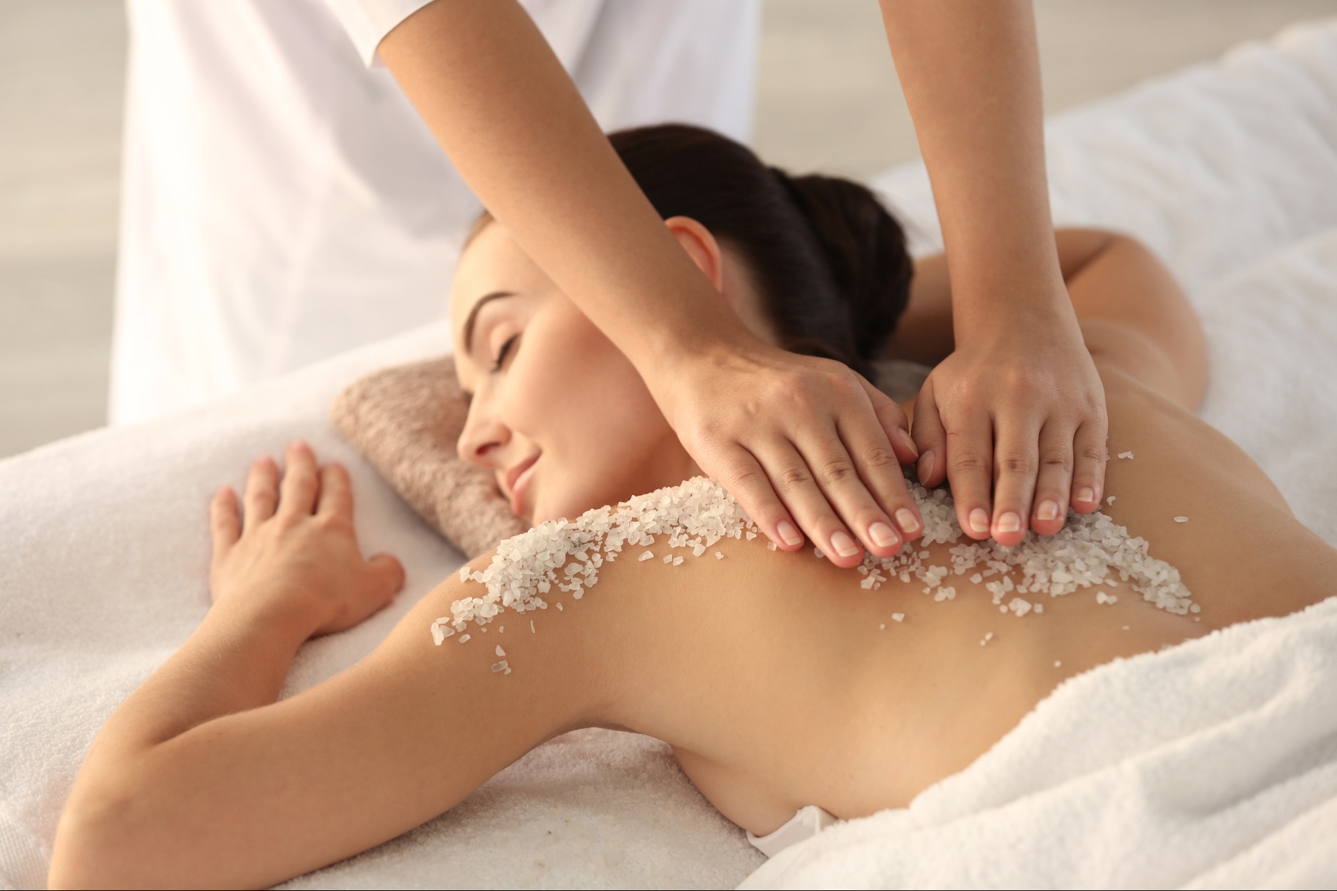 Organic Sugar Scrub Services being performed on the back of a client by TLC Massage's Licensed Massage Therapist