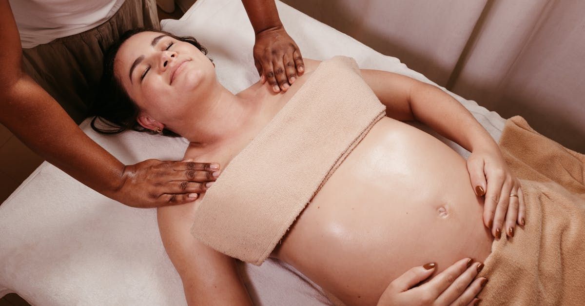Pregnant woman getting a massage to relive common strains and muscle issues faced by pregnant women