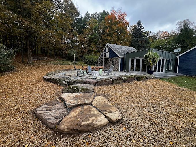 There is a fire pit in the backyard of a house.