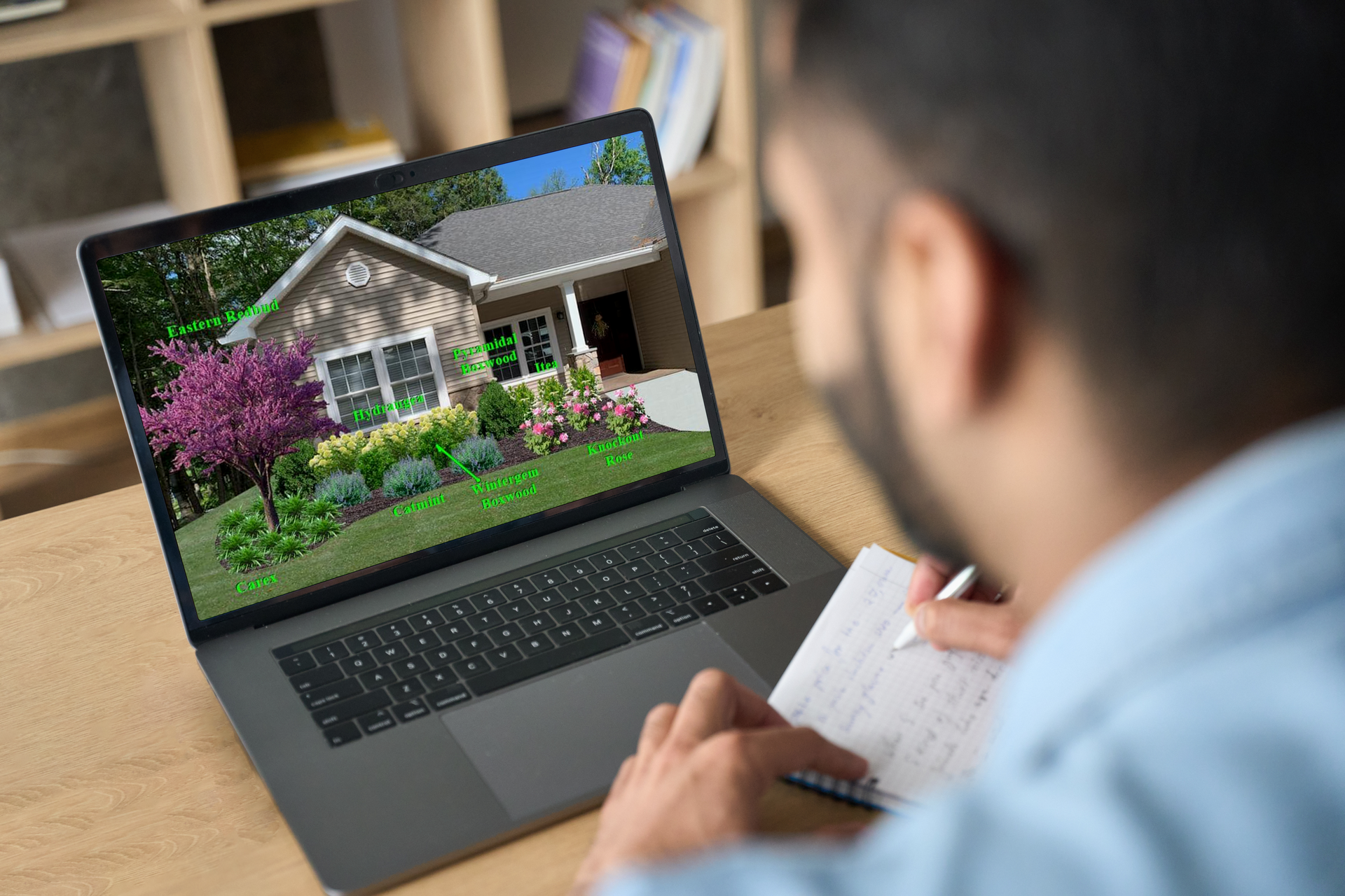 A man is looking at a picture of a house on a laptop computer.