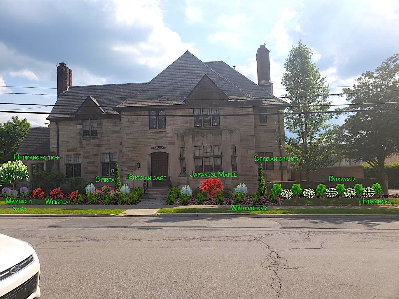 A large brick house with a car parked in front of it.