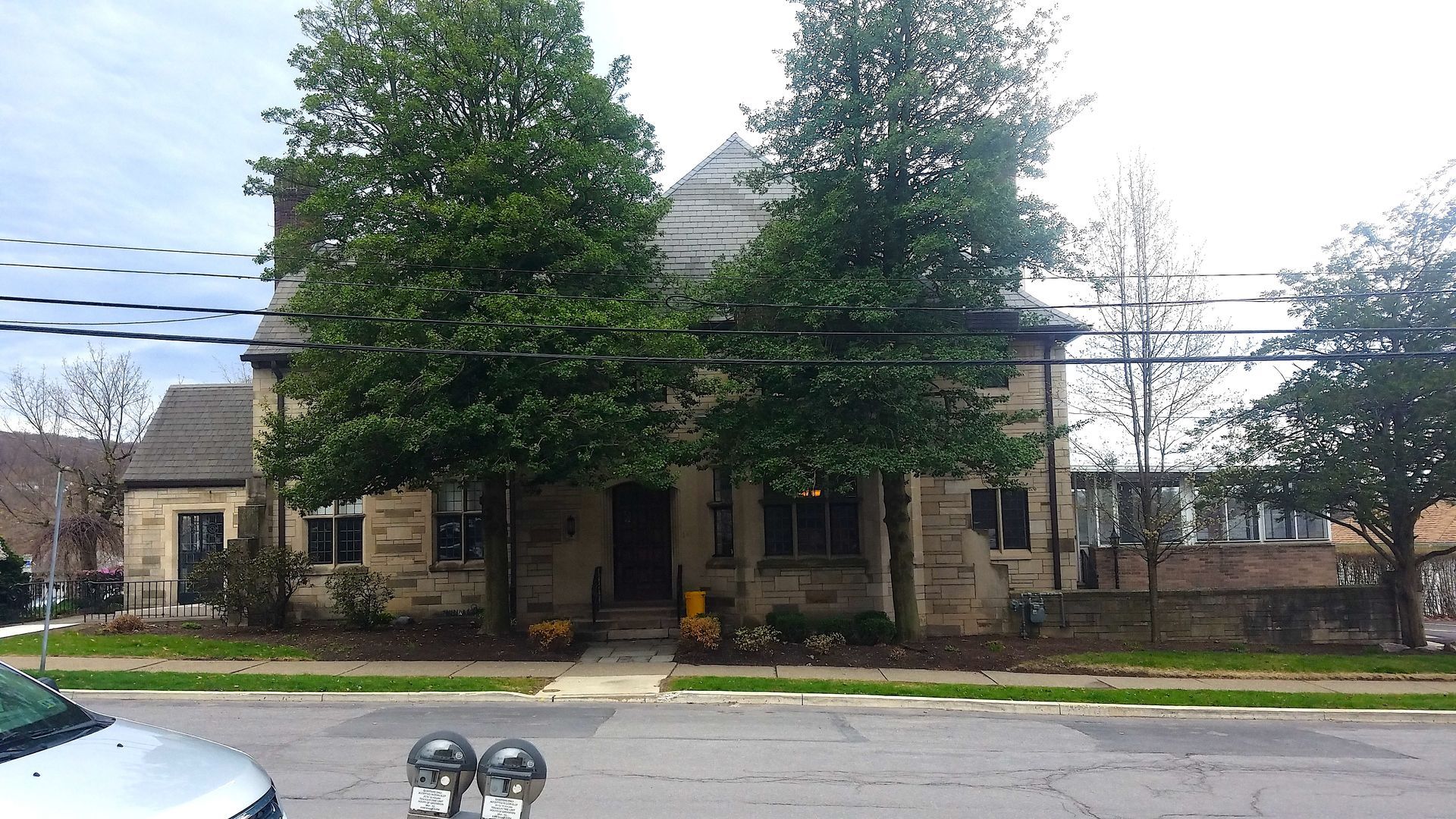 A house with a lot of trees in front of it