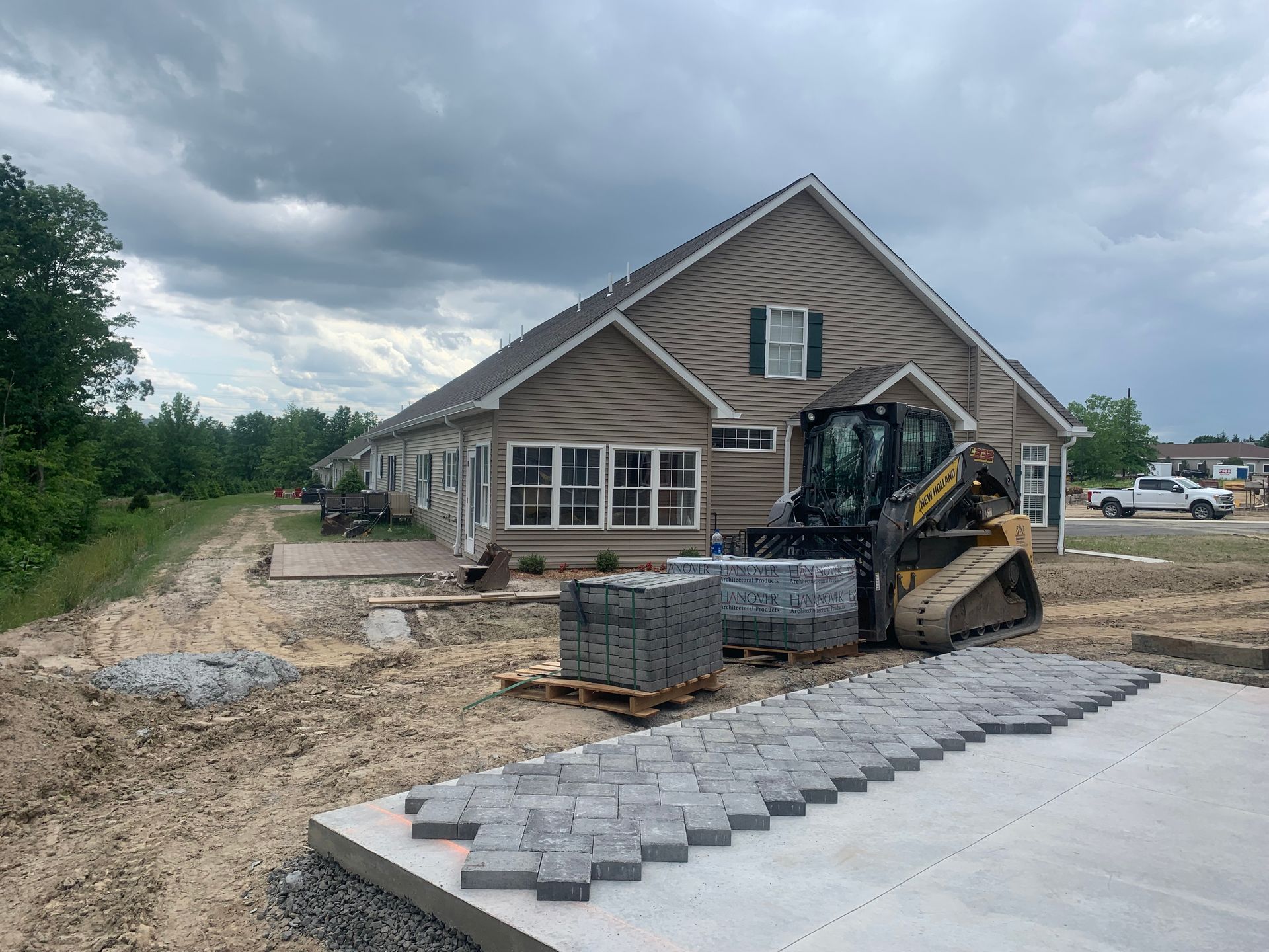 A house is being built with a bulldozer in front of it.