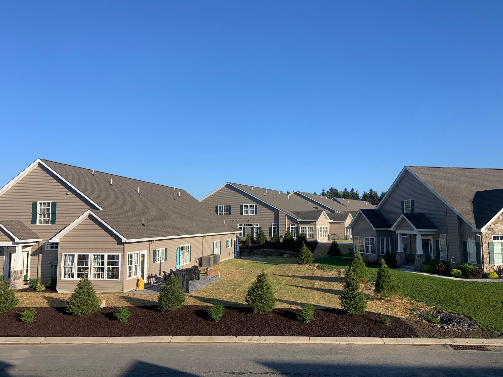 A row of houses with a blue sky in the background