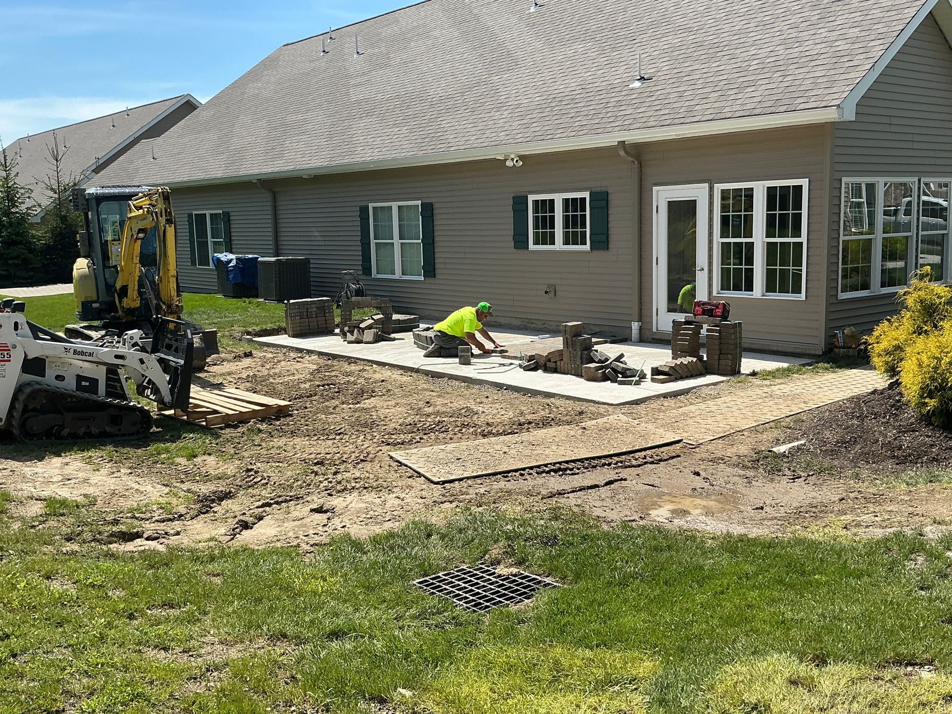 Gene laying paver patio at Summit Woods.