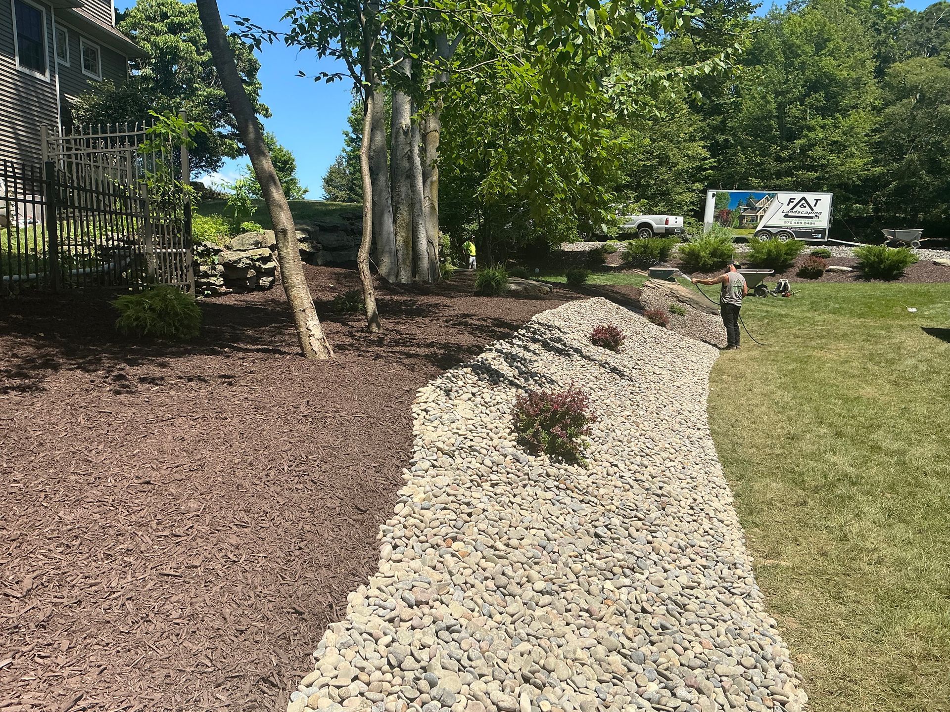 New mulch, river rock, fresh plants and a more sustainable landscape design.