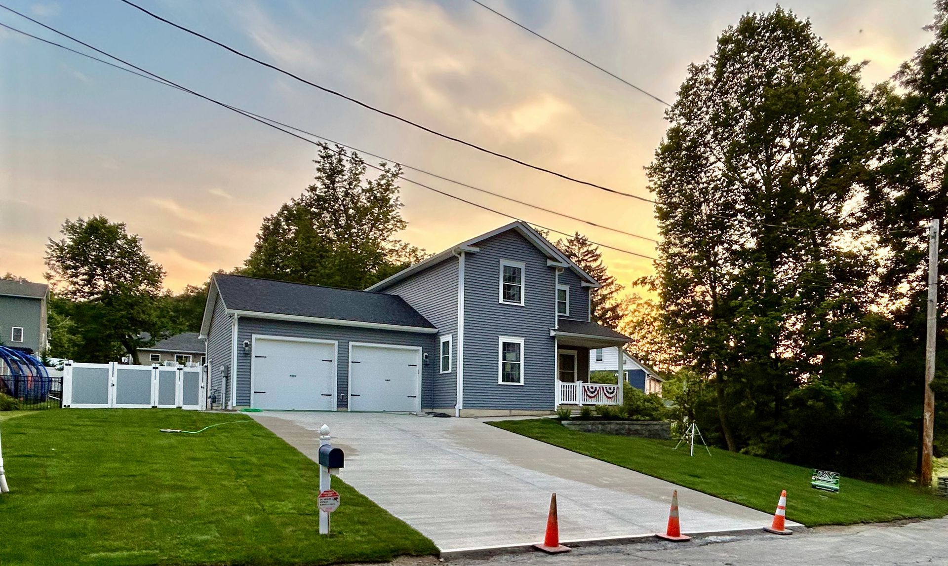 A house with two garages and a driveway in front of it