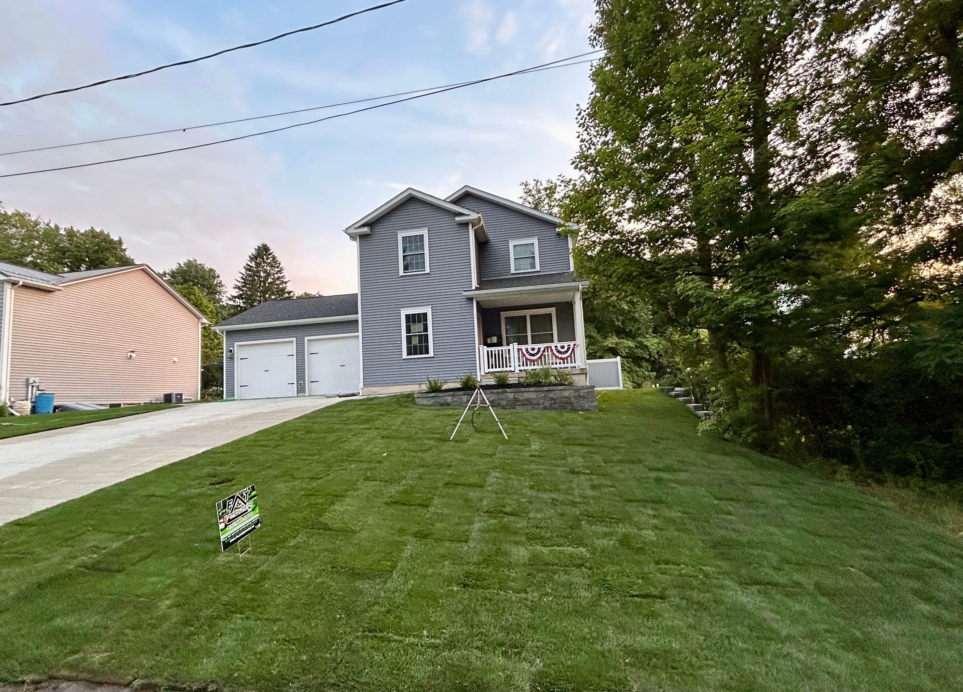 A house with a large lawn in front of it.