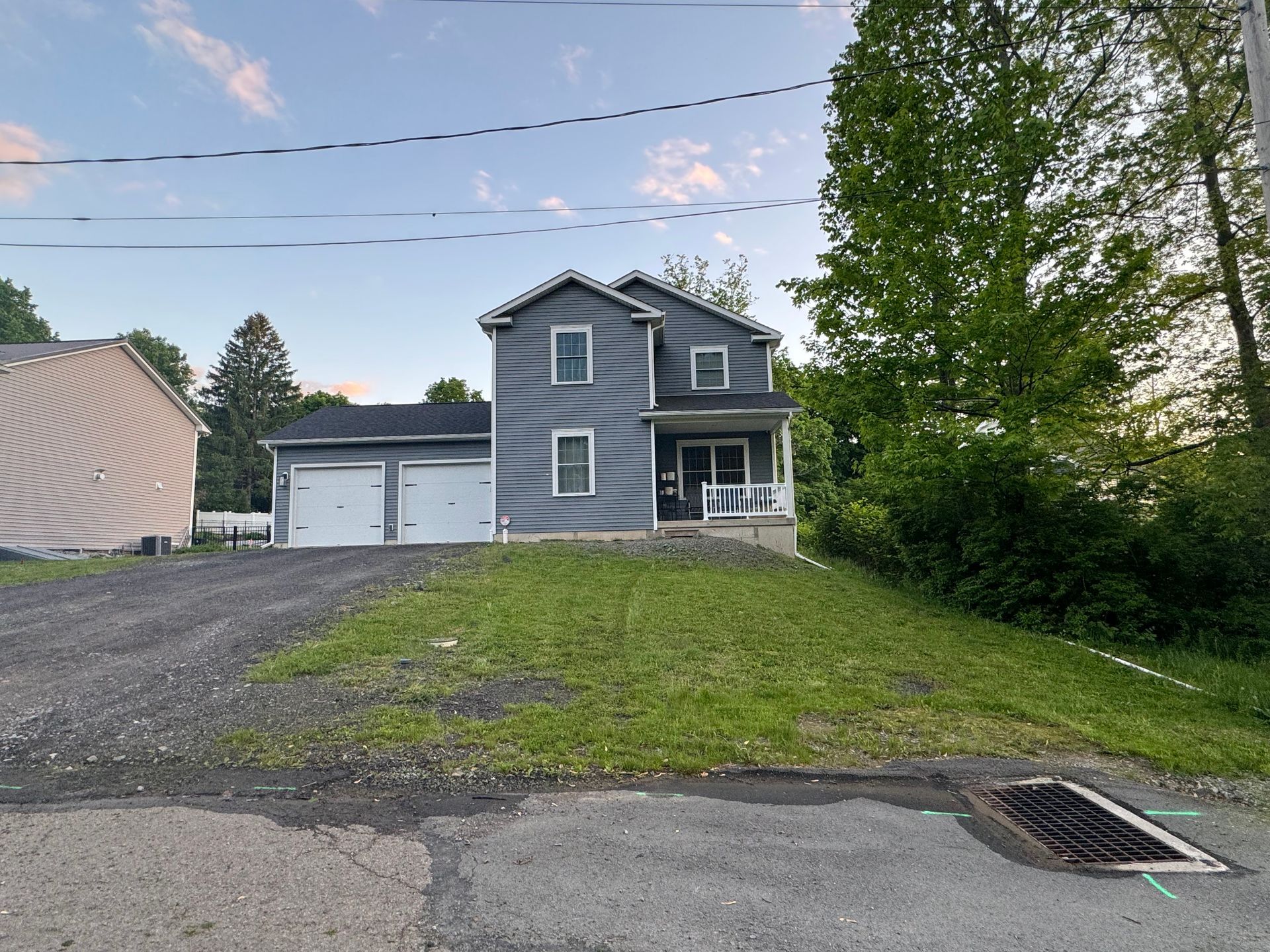 A house with a garage and a driveway in front of it.