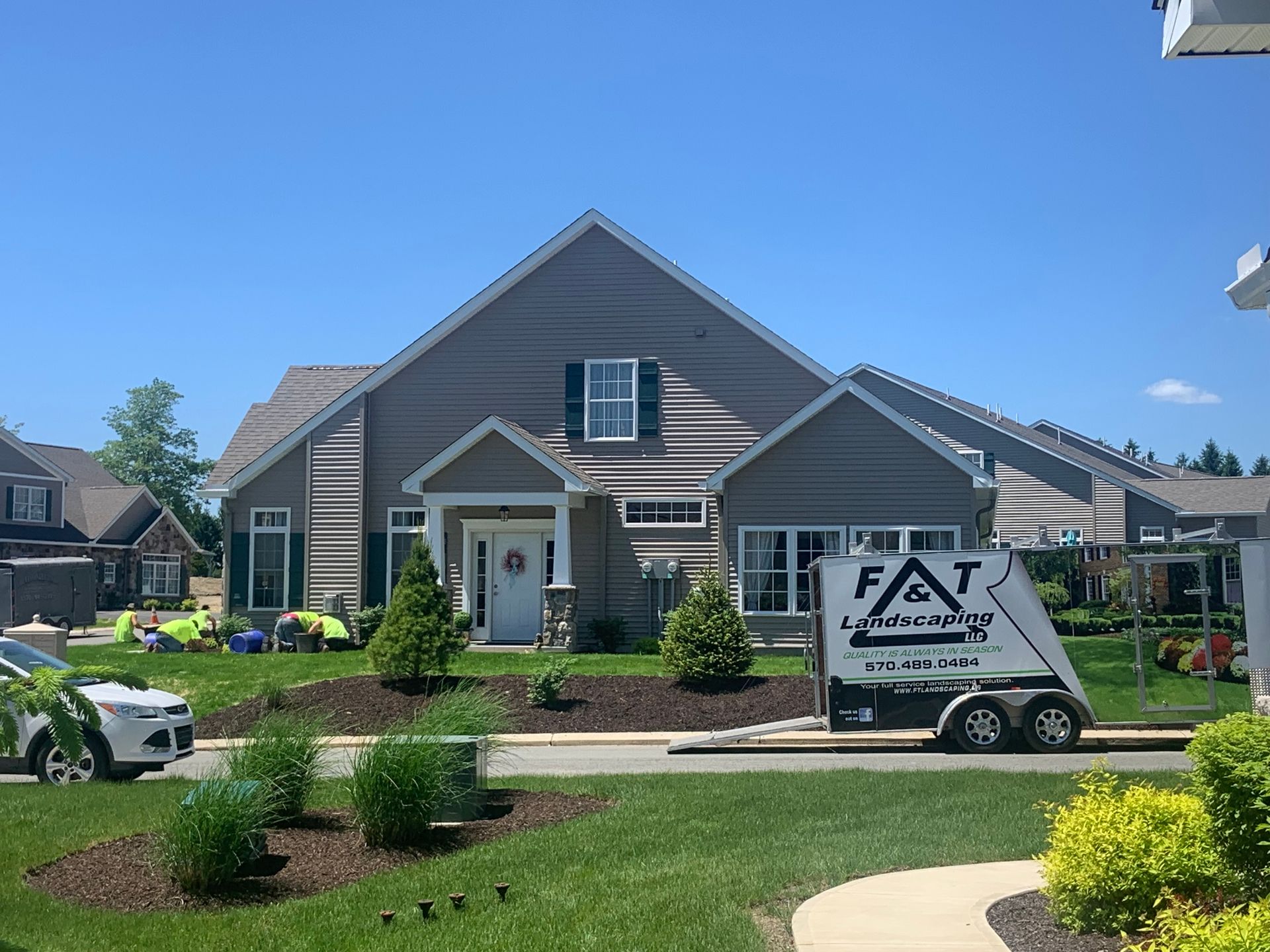 A beautiful home on a sunny day with a well maintained yard and landscaping.