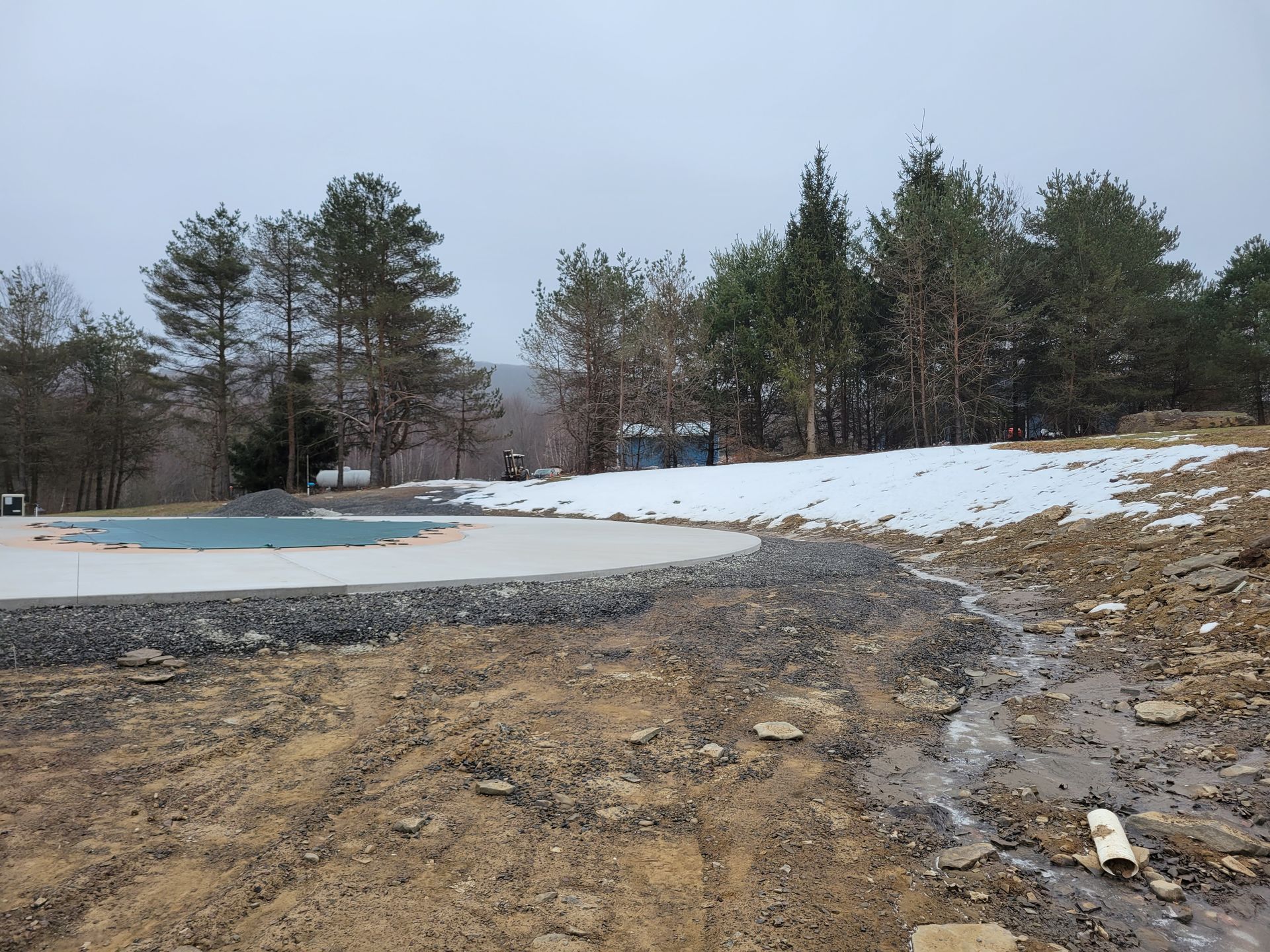 A swimming pool in the middle of a snowy field