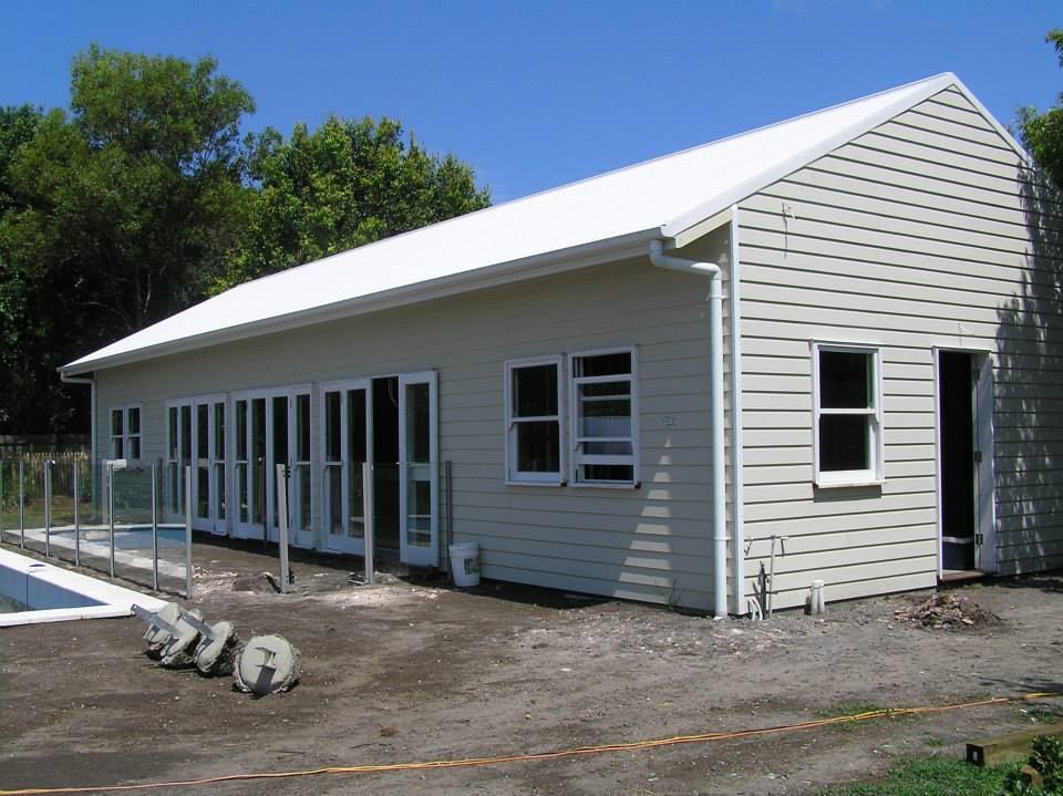 A House With A White Roof And A Lot Of Windows — Austeel Sheds in Bowen, QLD