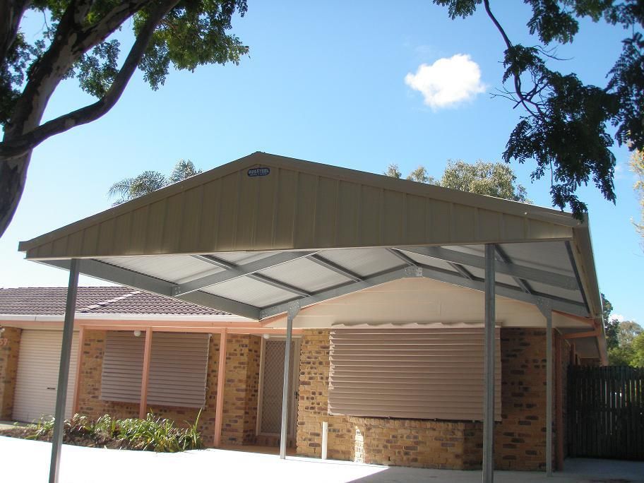 A House With A Carport In Front Of It — Austeel Sheds in Bowen, QLD