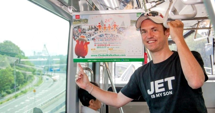 Bryce Conlan pointing to a Walkathon poster